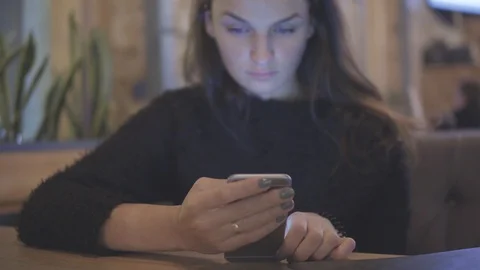 Internet, communication and technology concept - woman with cell phone in cafe Stock Footage 88611198