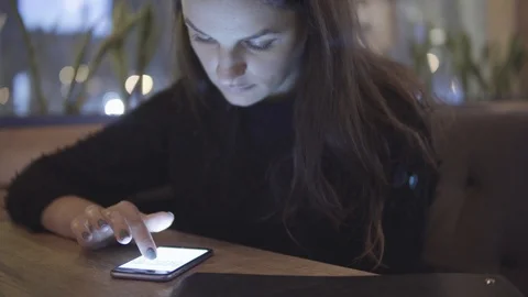 Internet, communication and technology concept - woman with cell phone in cafe Video stock 88611217