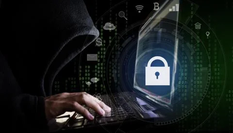 Internet network security system. Hacker in black hoodie using computer laptop Stock Photos