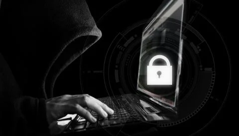 Internet network security system. Hacker in black hoodie using computer laptop Stock Photos