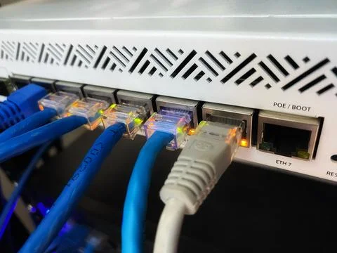 Internet or UTP network cable connected to the patch panel or router Stock Photos