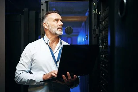 Internet, programmer and man in server room, laptop and cyber security with.. Stock-Fotos