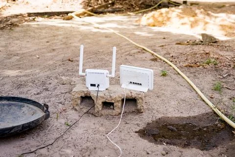 Internet router and modem seen in african garden outdoors, concept of 库存照片