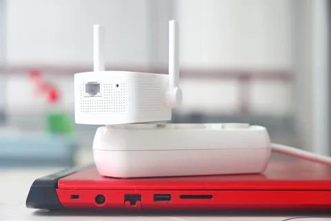 Internet signal booster in a socket, an Internet signal amplifier lies on a.. Foto stock