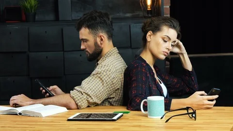 Internet surfing instead converation Stock Footage 92139376