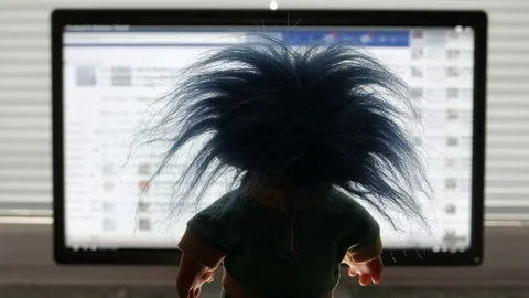 Internet Troll with blue hair is checking a social media account Vídeos de archivo 75693516