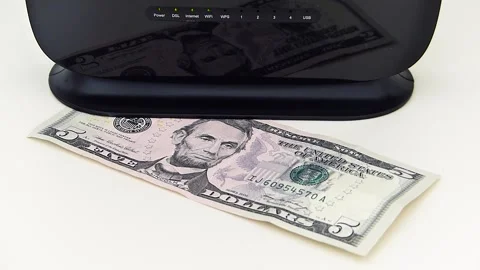 Internet usage fee increase in the world, modem and 5 dollars stand next to i Stock Footage 162120196