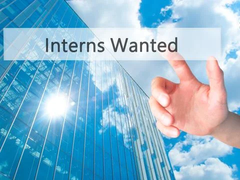 Interns Wanted - Hand pressing a button on blurred background concept on visu Stock Photos