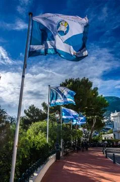 Interplay of blue flags on sky background in Monaco Stock Photos