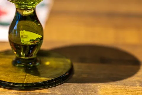 The interplay of light and shadow on the emerald green glass stem and the w.. Stock Photos