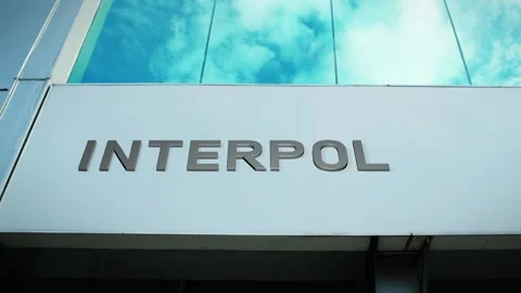 Interpol Sign on Modern Building with Cloud Reflection on Windows Glass Stock Footage 303560334