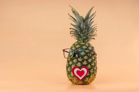 Interpretation of pineapple fruit in human image with glasses and heart concept Stock Photos