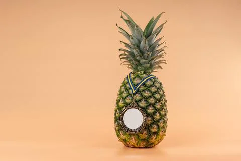 Interpretation of the pineapple fruit into a human image with a medal as a Stock Photos