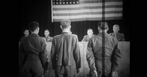 Interpreter, German civilian and Nazi commandant stand in front of judges Stock Footage