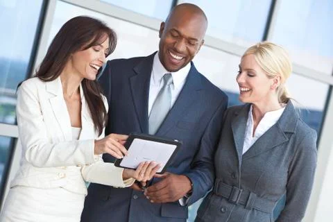 Interracial business team using tablet computer Stock Photos