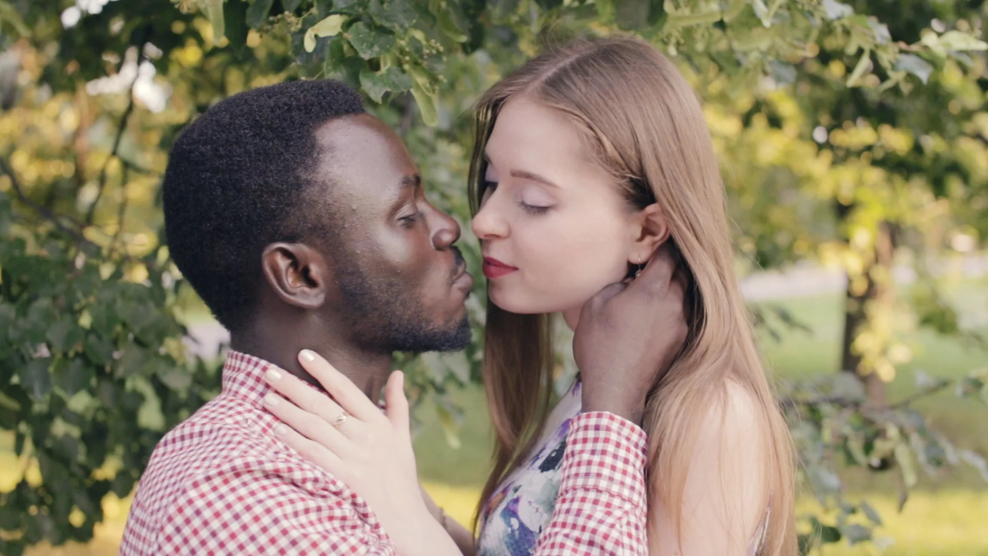 interracial couple is kissing. black afr... 