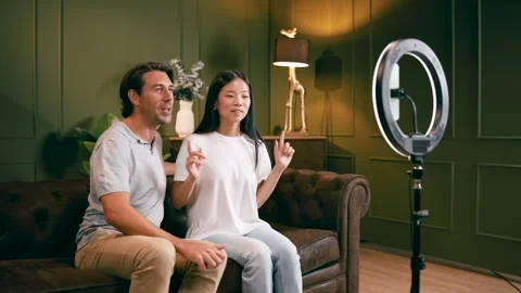 Interracial couple live streaming using a smartphone Stock Footage 343626072