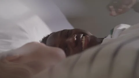 Interracial Couple Lying On Bed Smiling Stock Footage 270295970