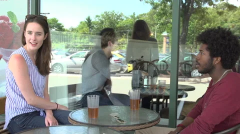 An interracial couple, outside a restaurant, order dinner. Stock Footage 44116419