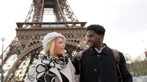 Interracial couple smiling and walking near the eiffel tower Stock Footage 327446840
