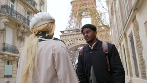 Interracial couple talking together in paris near the eiffel tower Stock Footage 327446829