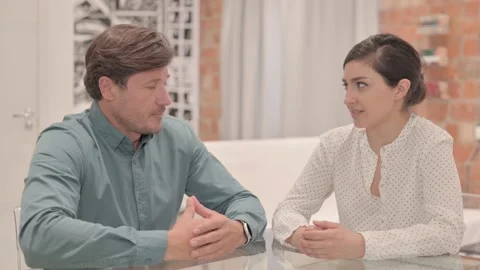 Interracial Couple Talking while Sitting at Home Stock Footage 238647106