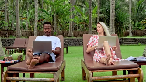 Interracial couple team work. Freelance people use laptop. Multicultural pair. Stock Footage 246407298