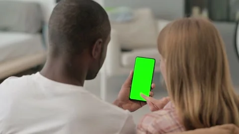 Interracial Couple Using Phone with Green Screen Stock Footage 287911850
