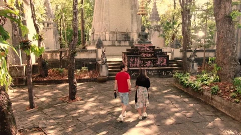 Interracial Couple Walking inside a Mysterious Buddhist Temple Stock Footage 156970729