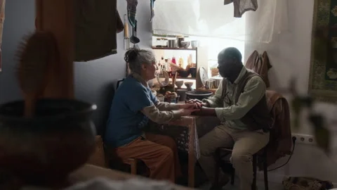 Interracial Elderly Couple Holding Hands While Having Supportive conversation Stock Footage 314621952