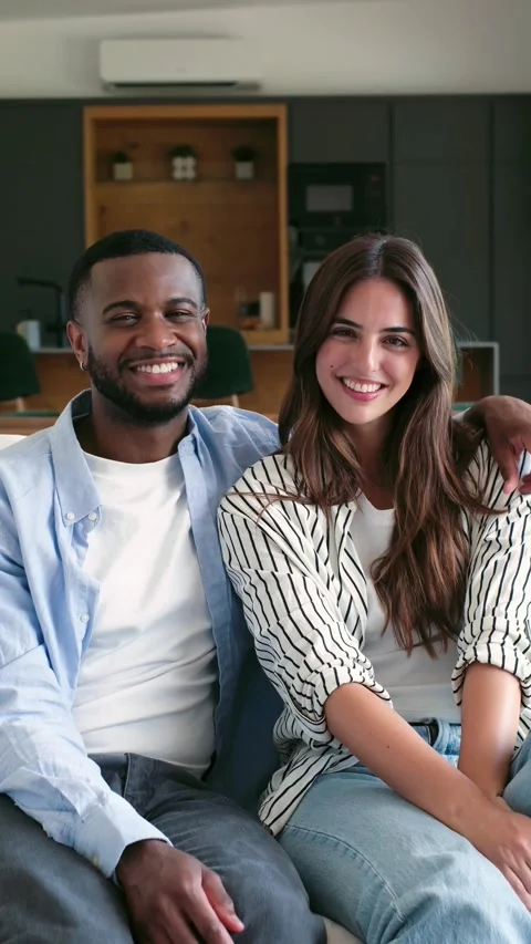 Interracial happy couple smiling at camera at home Stock Footage 335588119