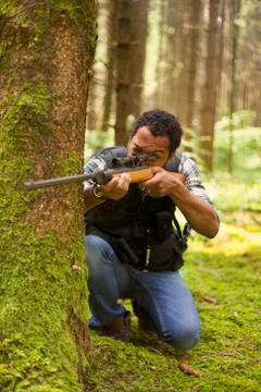 Interracial hunter in the forest Stock Photos