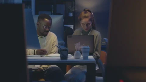 Interracial Programmers Couple Co-working in Office at Night Stock Footage 259161700