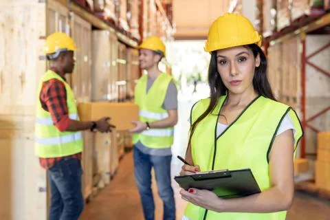 Interracial Warehouse worker in distribution warehouse. Stock Photos
