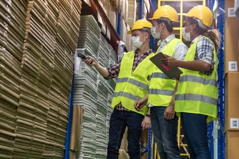 Interracial warehouse workers team do inventory. 库存照片