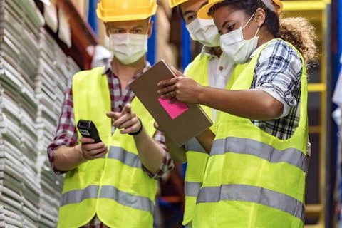 Interracial warehouse workers team do inventory. Interracial team Asian Af... Stock Photos