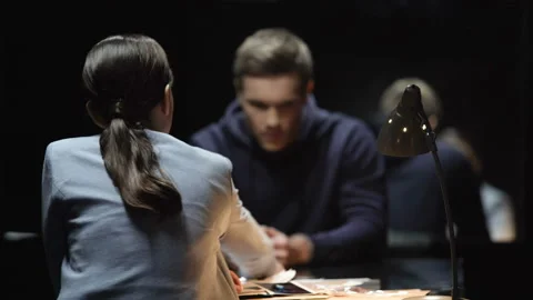 Interrogating lady pressing criminal man and he denying guilt, bad cop technique Stockbeeldmateriaal 86114140