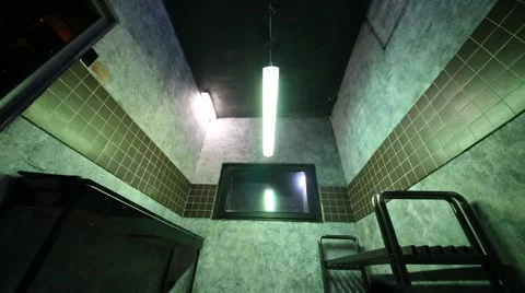 Interrogation room with mirror, bench and long lamp Vídeos de archivo 64474990