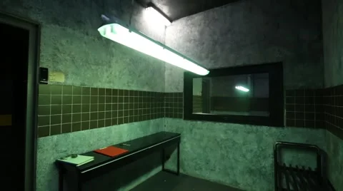 Interrogation room with mirror, table, benches and swinging lamp. 動画素材 64474981