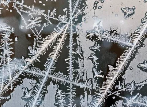 Intersecting to frost line, patterns on the window glass Stock Photos
