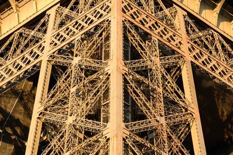 Intersecting iron beams of Eiffel Tower at sunset 写真素材