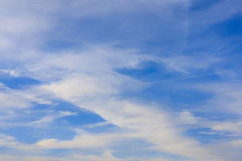 Intersecting lines of beautiful cirrus clouds in a bright blue sky. Stock Photos