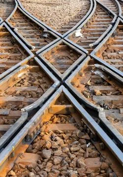 Intersecting train tracks symbolizing choice direction and transport Фото
