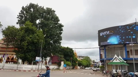 Intersection with electronic billboard, traffic, temples, Vientiane center, Laos 스톡 동영상 75822083