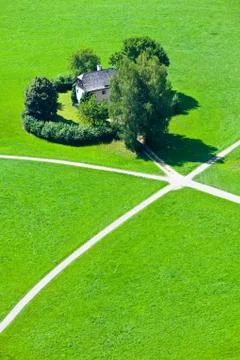 Intersection of five walking paths in green field Stock Photos