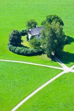 Intersection of five walking paths in green field Stock Photos