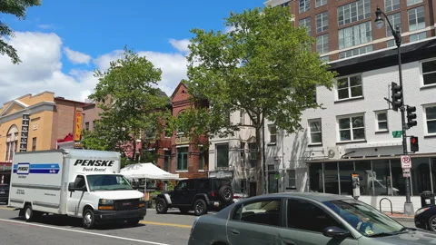 Intersection framed by brick homes and shops Stock Footage 324762089