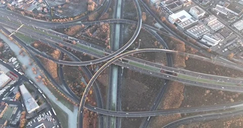 Intersection of multileveled interchange roadway. Traffic on a roundabout Video stock 228843553