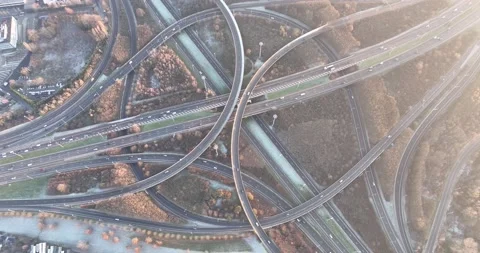Intersection of multileveled interchange roadway. Traffic on a roundabout Stock Footage 229429140