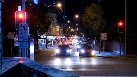 An intersection at night traffic lights vehicles time-lapse Stock Footage 100174164